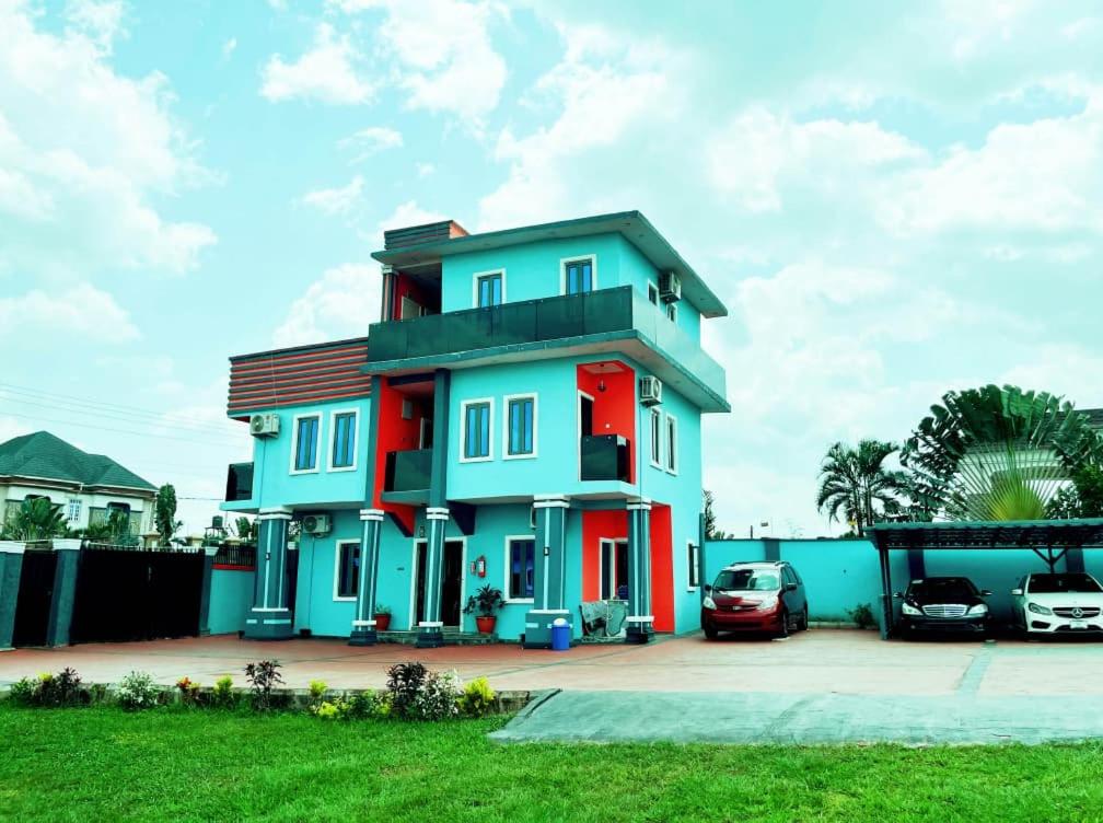 a house with two cars parked in front of it at Skye Palace Apartment - Skye Regency 2 Bedroom Apartment in Akure