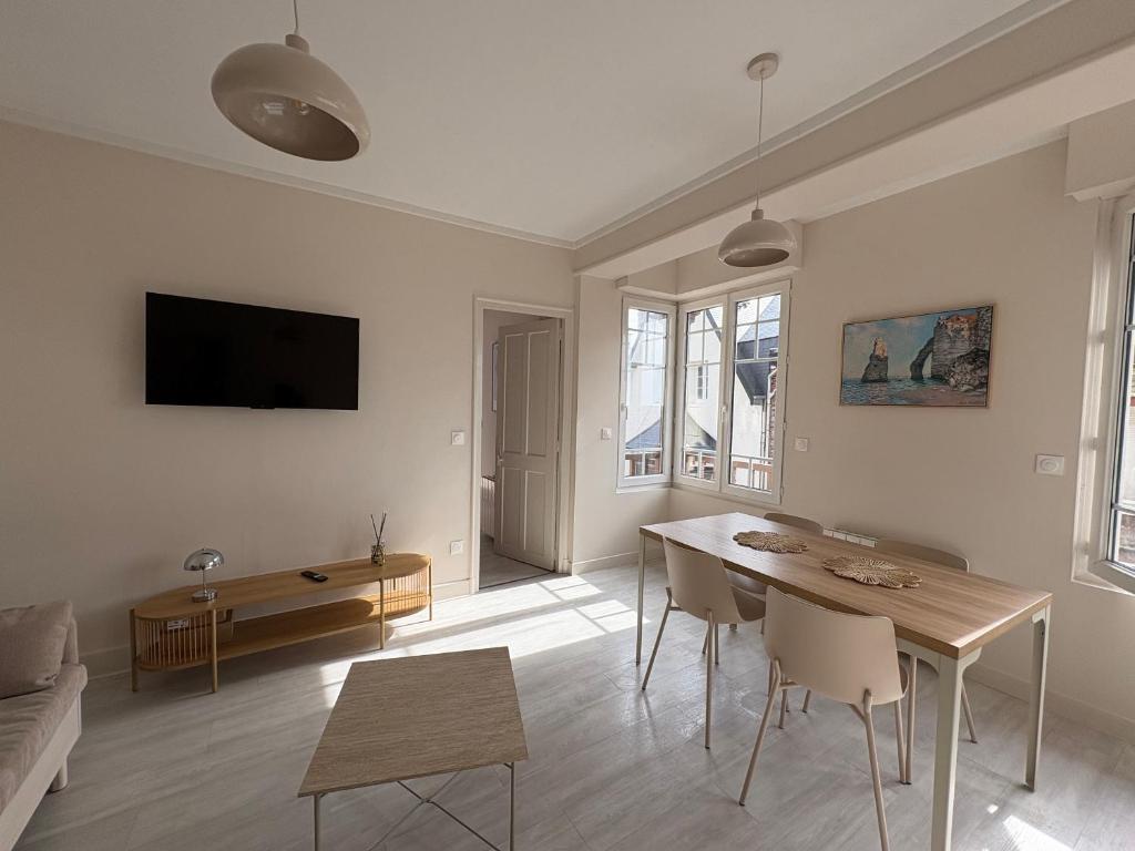a white living room with a table and a couch at L'Eclat Marin échappée mer in Étretat