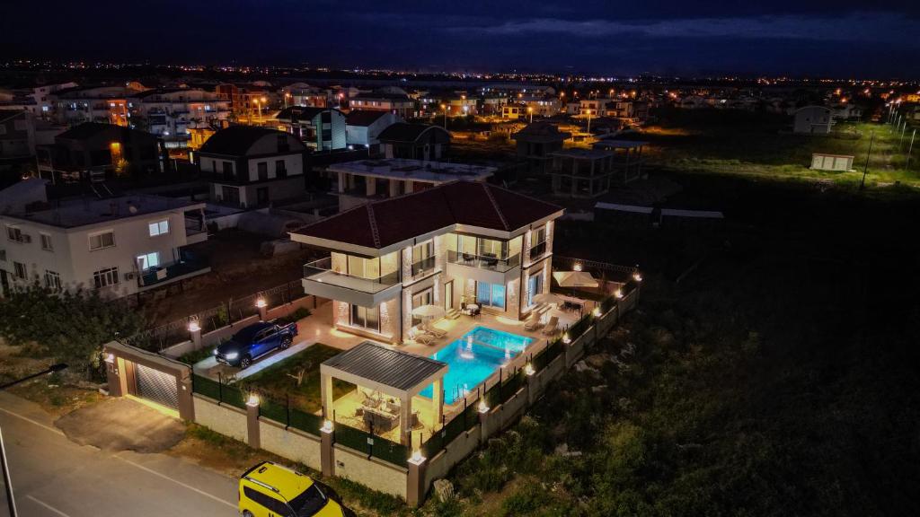 an aerial view of a house with a swimming pool at night at Vıllaozden in Belek