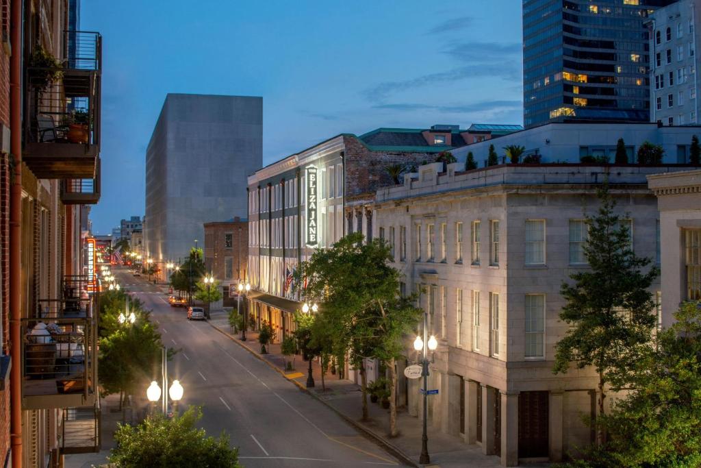 a city street at night with buildings and street lights at The Eliza Jane, Autograph Collection in New Orleans