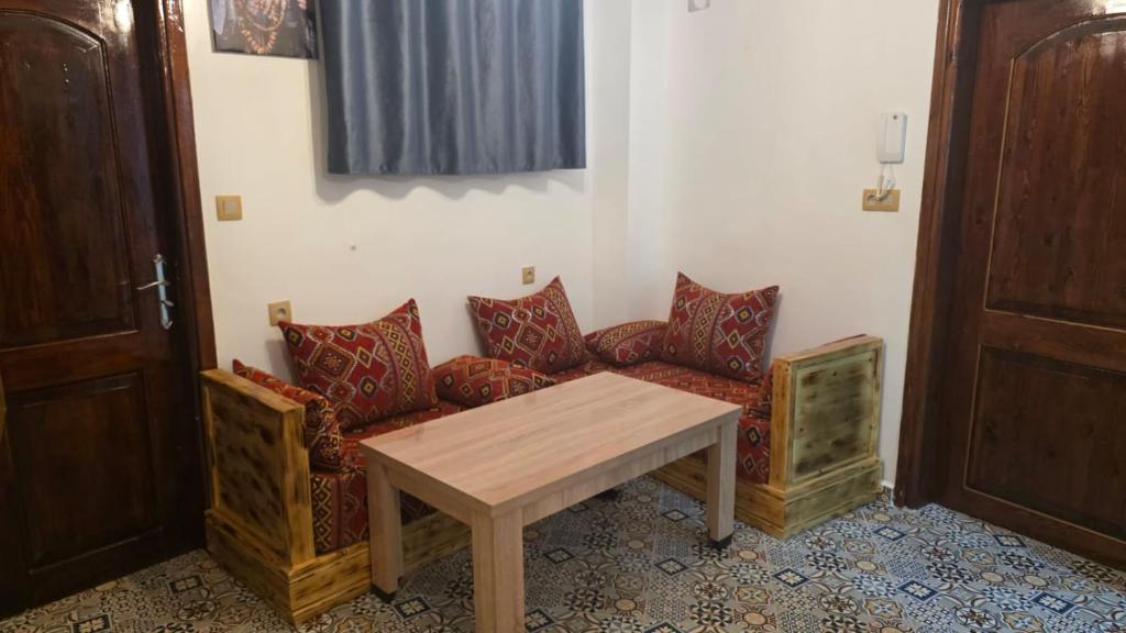 a living room with a couch and a table at Maison marhaba2 app 3 in Agadir