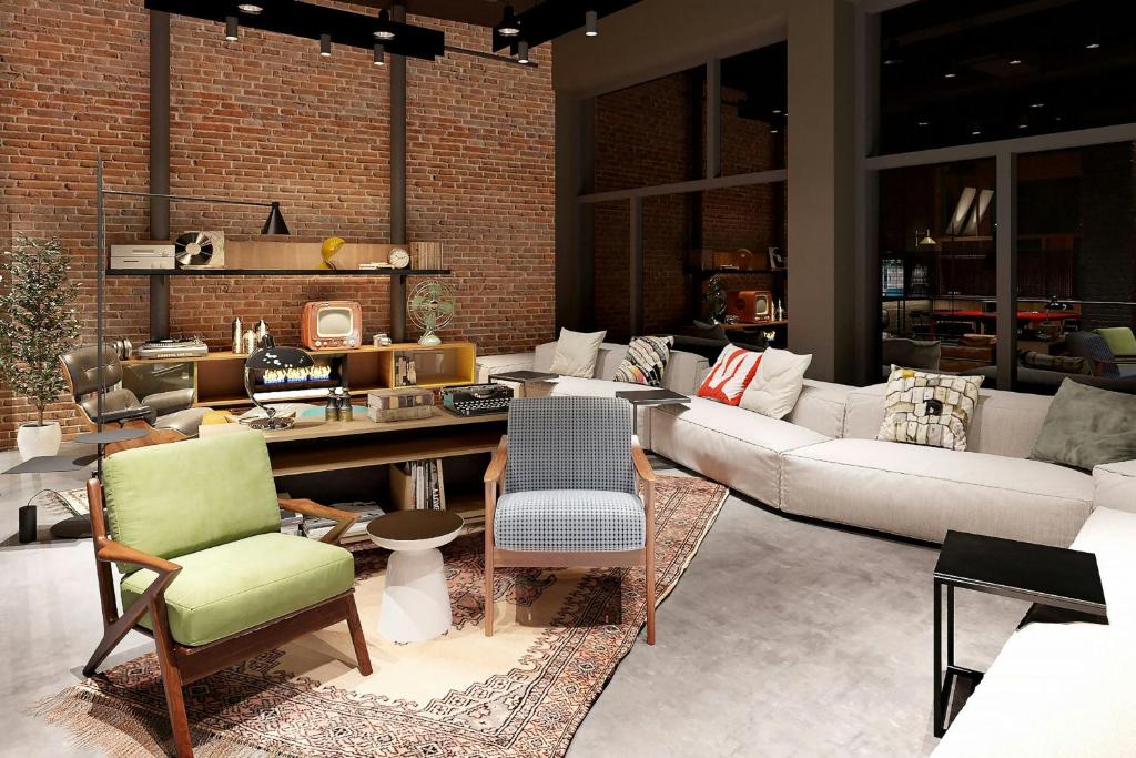 a living room with a couch and chairs at Moxy Belgrade Skadarlija in Belgrade