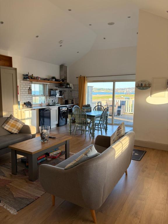 a living room with a couch and a table at Beautiful Seaside Cottage Wicklow town in Wicklow