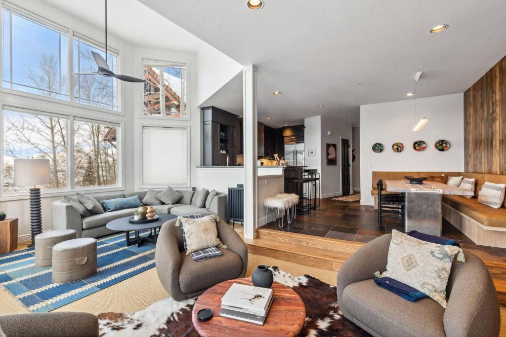 a living room with two couches and a kitchen at Pine Meadows 135 ~ Pine Meadows 135 in Telluride