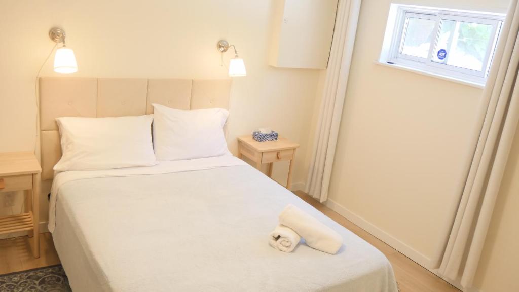 a bedroom with a bed with a teddy bear on it at Applewood Gardens Apartment in Mississauga