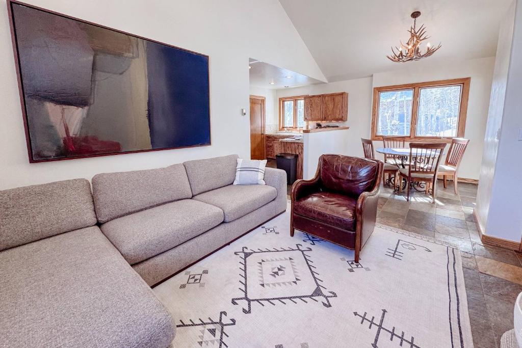 a living room with a couch and a dining room at Benchmark Dr 101 ~ Guest House in Telluride