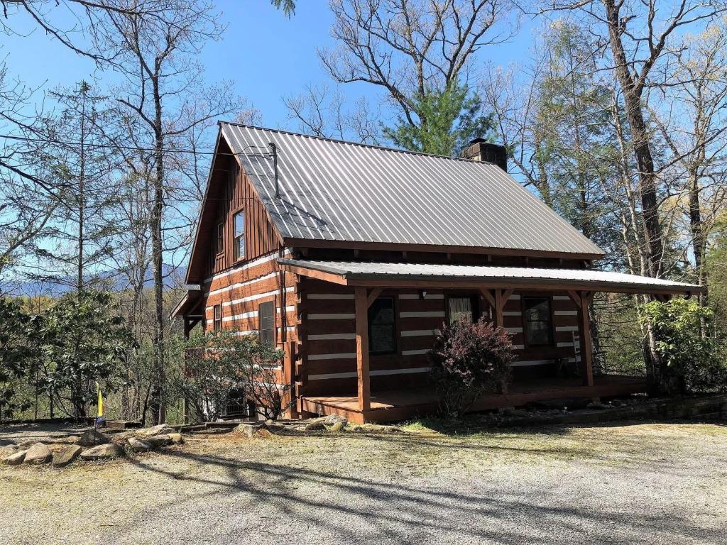 a log cabin with a gambrel roof at Ivy Retreat in Sevierville
