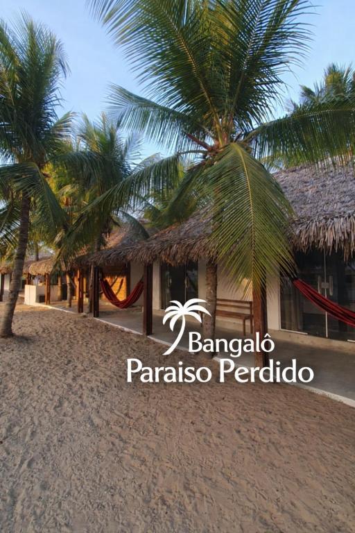 a resort on the beach with palm trees in the foreground at ArpoadorBangalôparaísoperdido in Tutóia