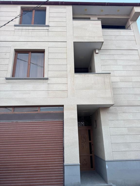 a building with a garage in front of it at Afyan's guest house in Yerevan