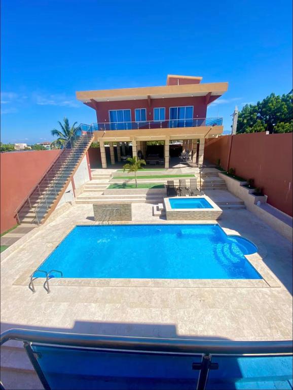 a house with two swimming pools in front of it at Villa Barias in Baní