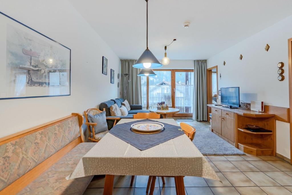 a living room with a table and a couch at Fewo Barth in Bad Hindelang