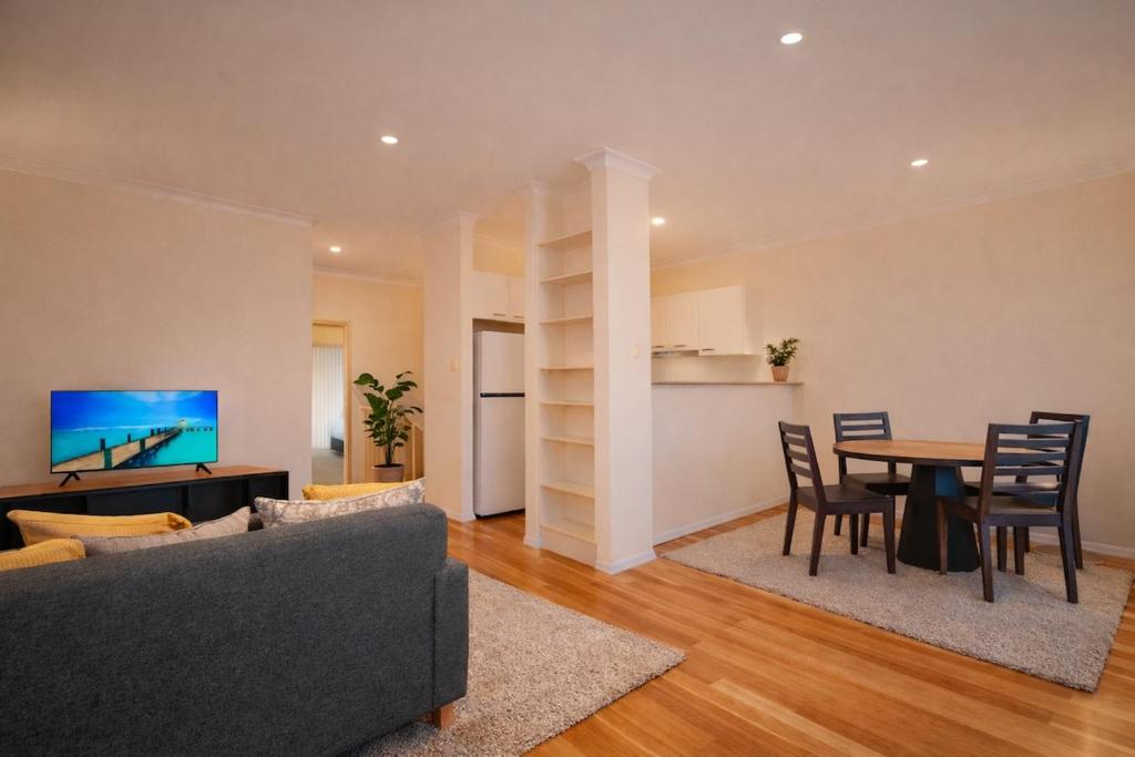 a living room with a couch and a table at Modern 2BR Townhouse with BBQ & Pool Access in Muswellbrook