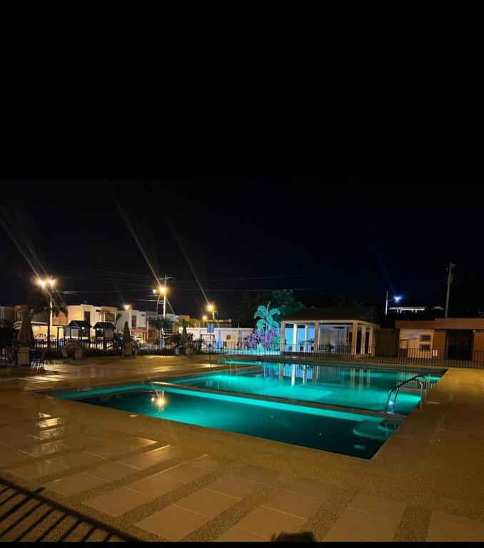 an empty swimming pool at night with lights at Urban Oasis in Manta