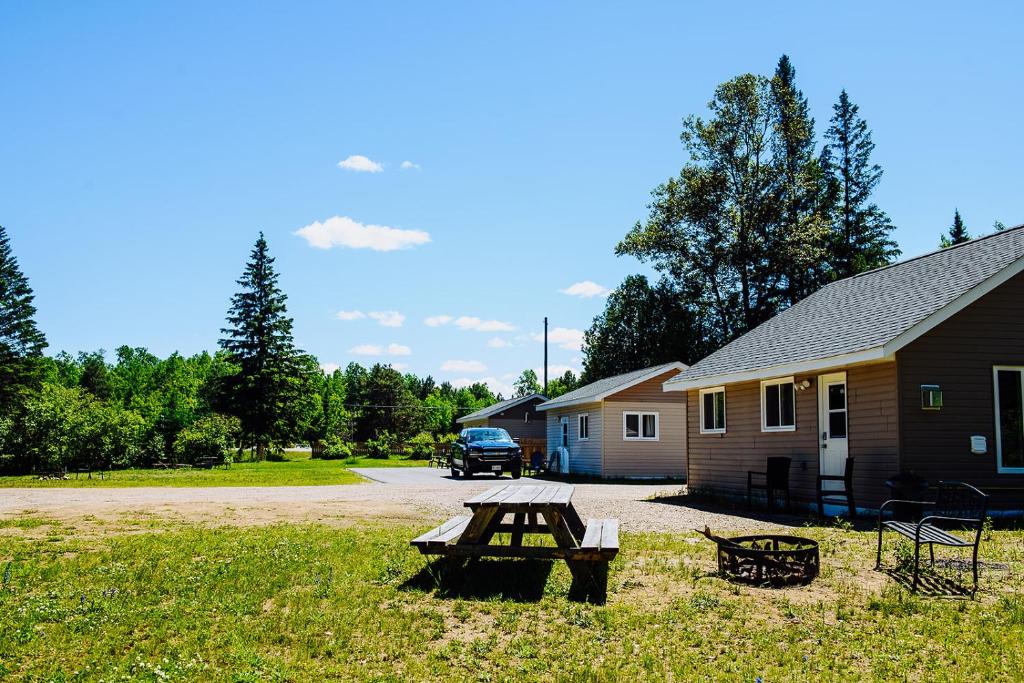 a picnic table in front of a house at Four Seasons Algonquin Cabins in Madawaska