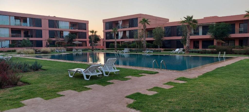 a building with a swimming pool in front of a building at Domaine de noria in Marrakesh