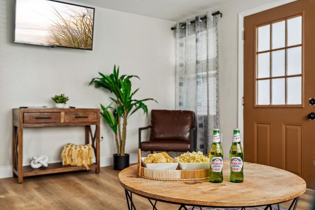 a table with two bottles of beer and a tray of food at NEW! Clearwater Gem, 10 Min to Beach, 2 Min to Downtown Dunedin, King Bed in Clearwater
