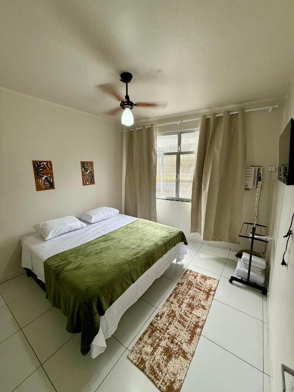 a bedroom with a bed and a ceiling fan at Angra Prime Centro in Angra dos Reis