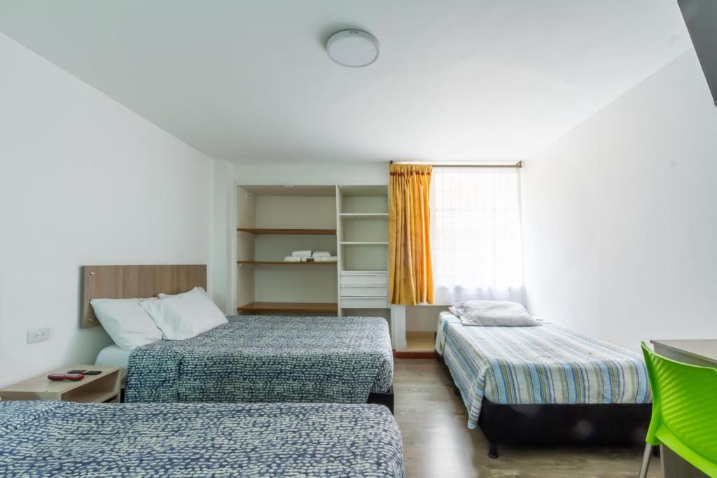 a hotel room with two beds and a window at Hospedaje Sary House in Bogotá