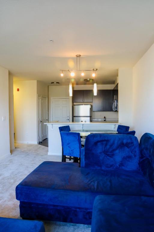 a living room with a couch and a kitchen at Cozy & inviting 2BD 2BTH Apt Home in Owings Mills