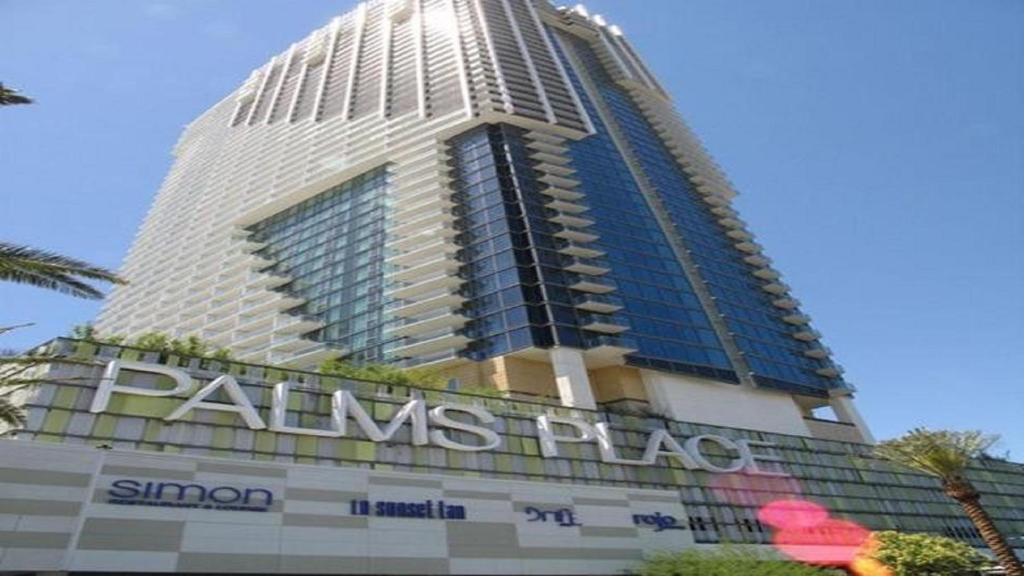 a tall building with a sign in front of it at Stunning 1 bedroom suite in Las Vegas