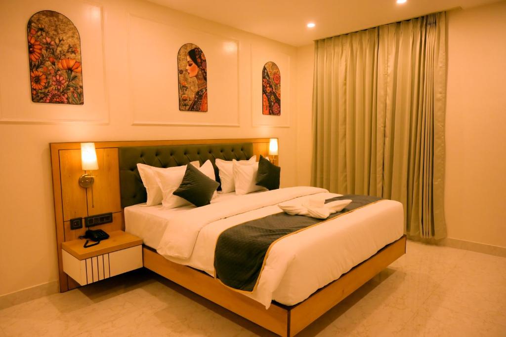 a bedroom with a large bed and a window at Hotel Grand Maspel in Dimapur