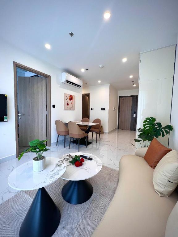 a living room with a couch and a table at MH Home in Long Bình