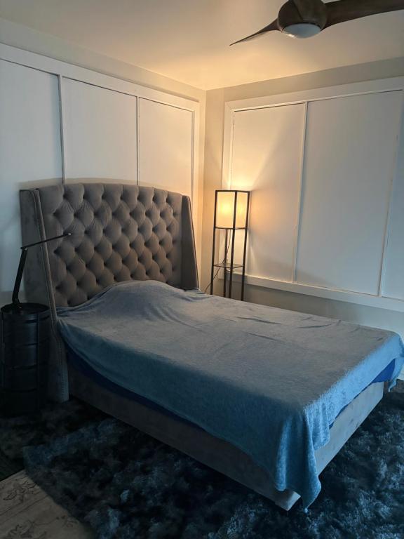 a bedroom with a bed with a tufted headboard at Private room with Fridge - Mini Mansion in Burbank