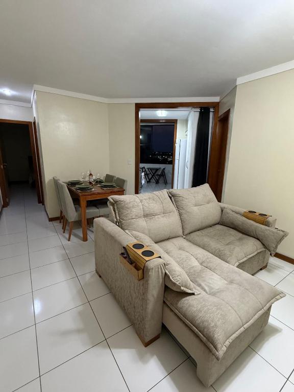 a living room with a couch and a table at Apartamento moderno - Amazonas Flat in Manaus