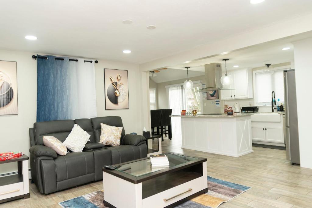 a living room with a couch and a kitchen at Juliet's Cozy Retreat in Worcester