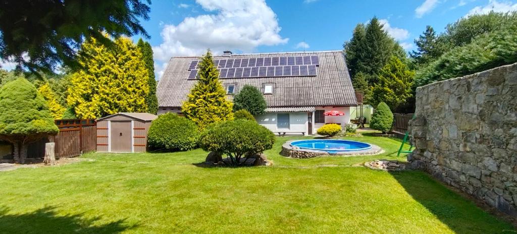 a house with a yard with a swimming pool at U Boží hory. in Žulová