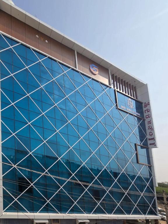 a blue building with a sign on the side of it at Sree Guru Sannidhi in Jāmb