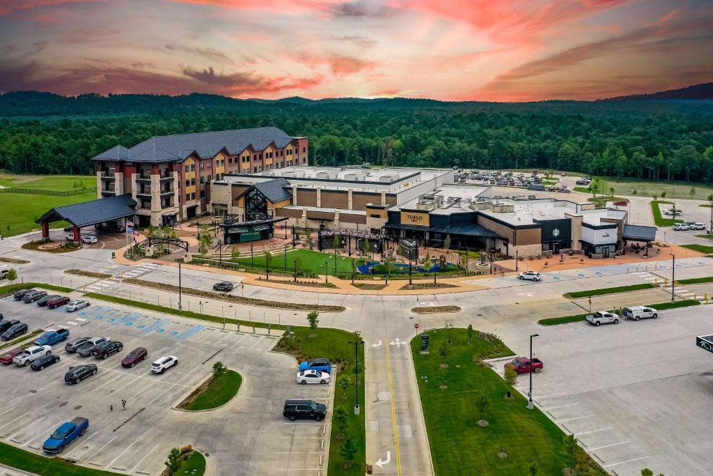an aerial view of a large building with a parking lot at Choctaw Landing Casino & Resort, Trademark Coll by Wyndham in Broken Bow