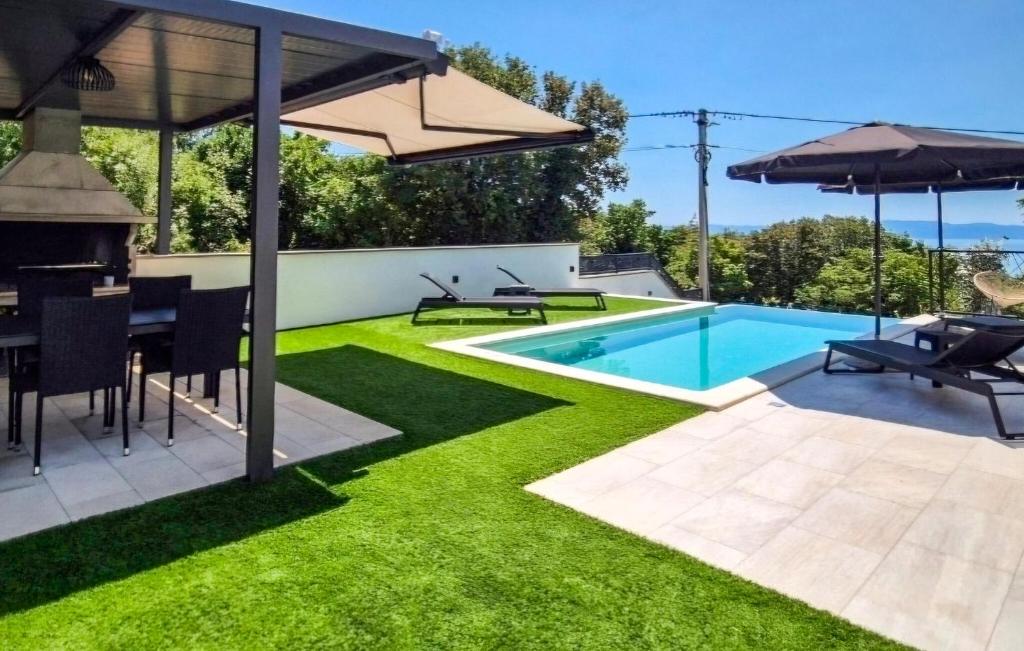 an image of a backyard with a swimming pool and grass at Beautiful Home In Kostrena in Kostrena