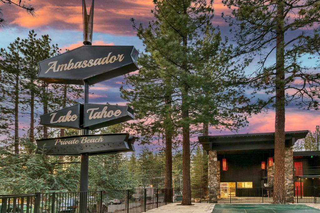 a sign in front of a house with trees at Ambassador Lake Tahoe in South Lake Tahoe