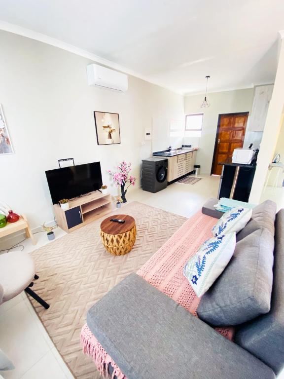 a living room with a couch and a table at The Exec Place Maun in Maun