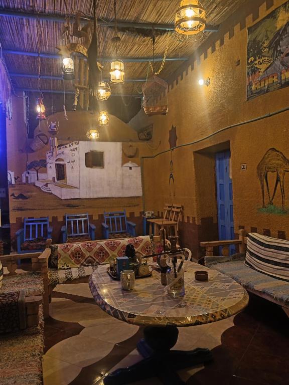 a room with a table and a couch in a room at Miral Nubian House in Aswan