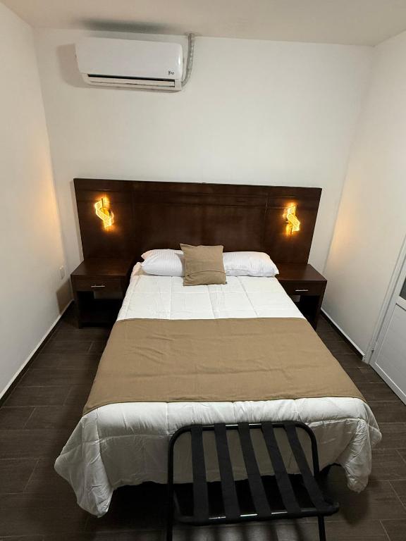 a bedroom with a large bed and two night stands at Casa Legado in Orizaba