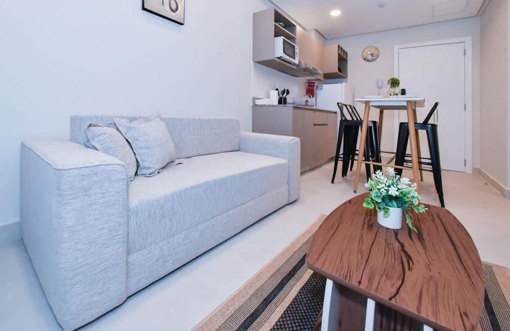 a living room with a couch and a table at Comfy Apt w Pool & Coworking in Fernando de la Mora