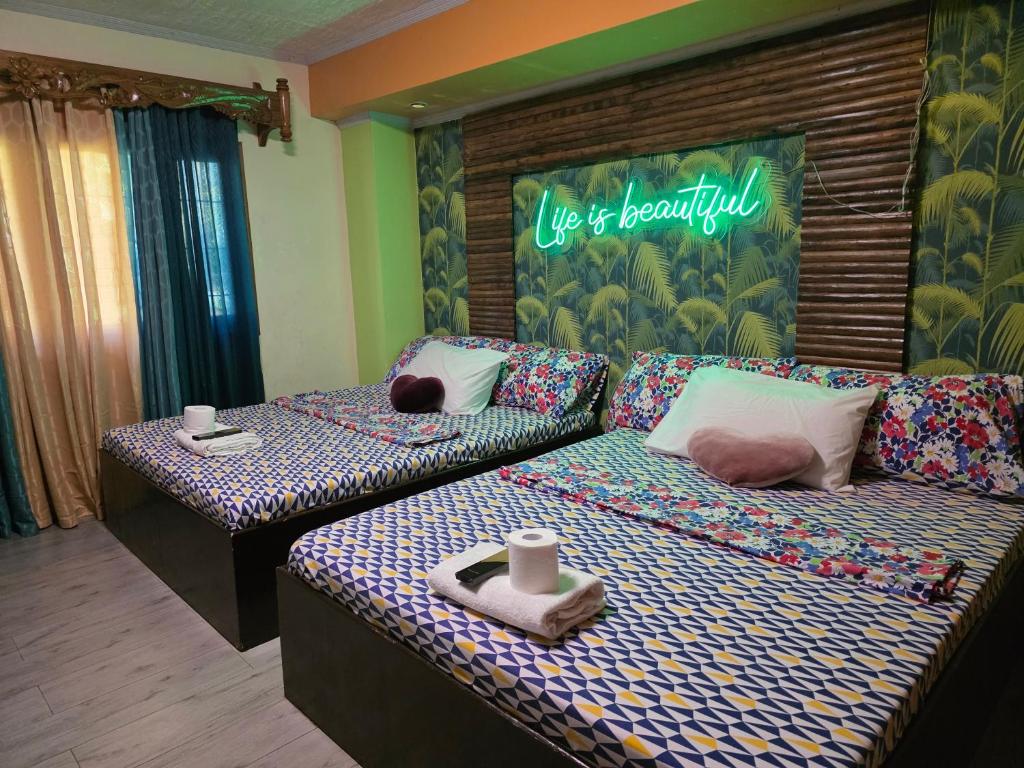 a room with two beds and a sign that reads us rehospital at La Leona Homestay in Hernani