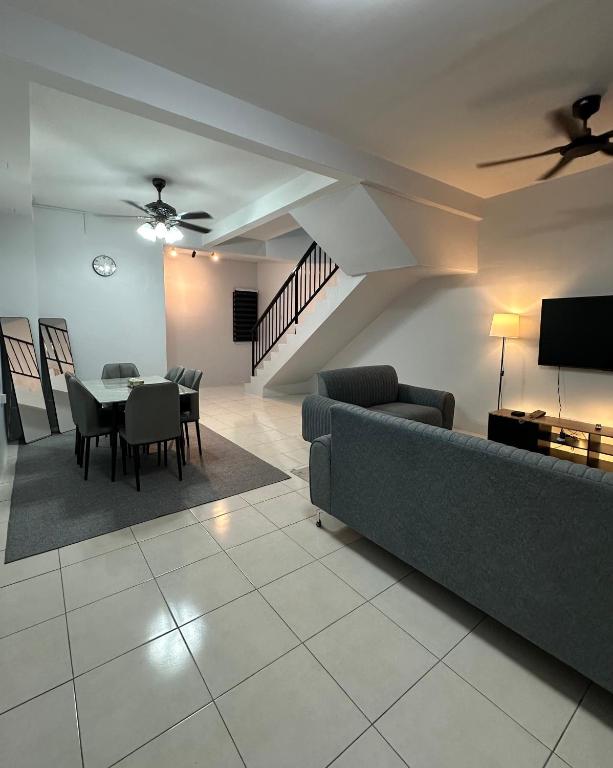 a living room with a couch and a table at Khaeel Homestay in Ipoh