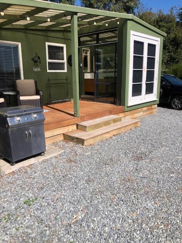 a green house with a stove in front of it at Fantail at Bluestone Retreat in Leeston