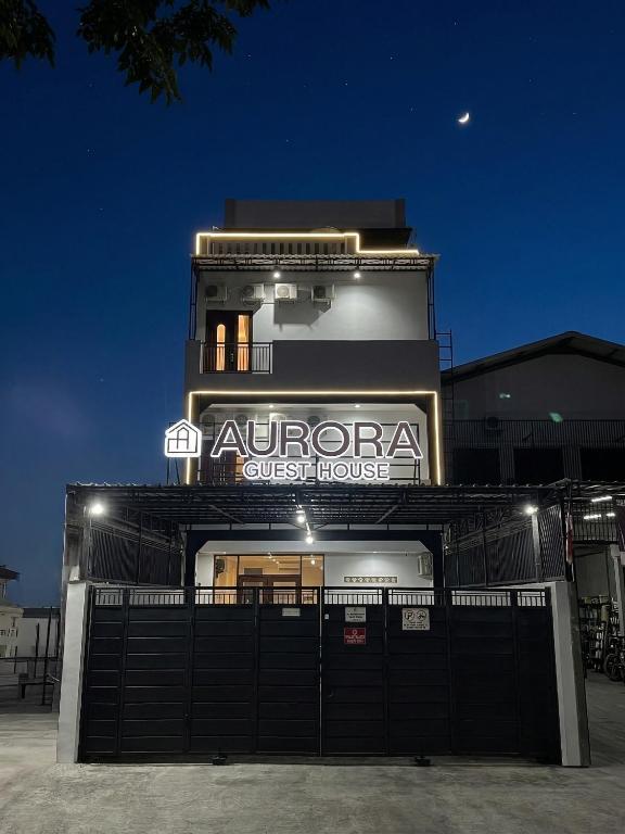 a building with a sign for a quest house at Aurora House Surabaya in Wijung