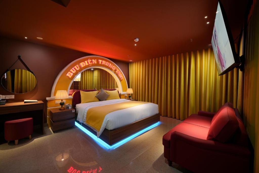 a bedroom with a king sized bed and a television at Chiic House Hải Phòng in Lực Hánh