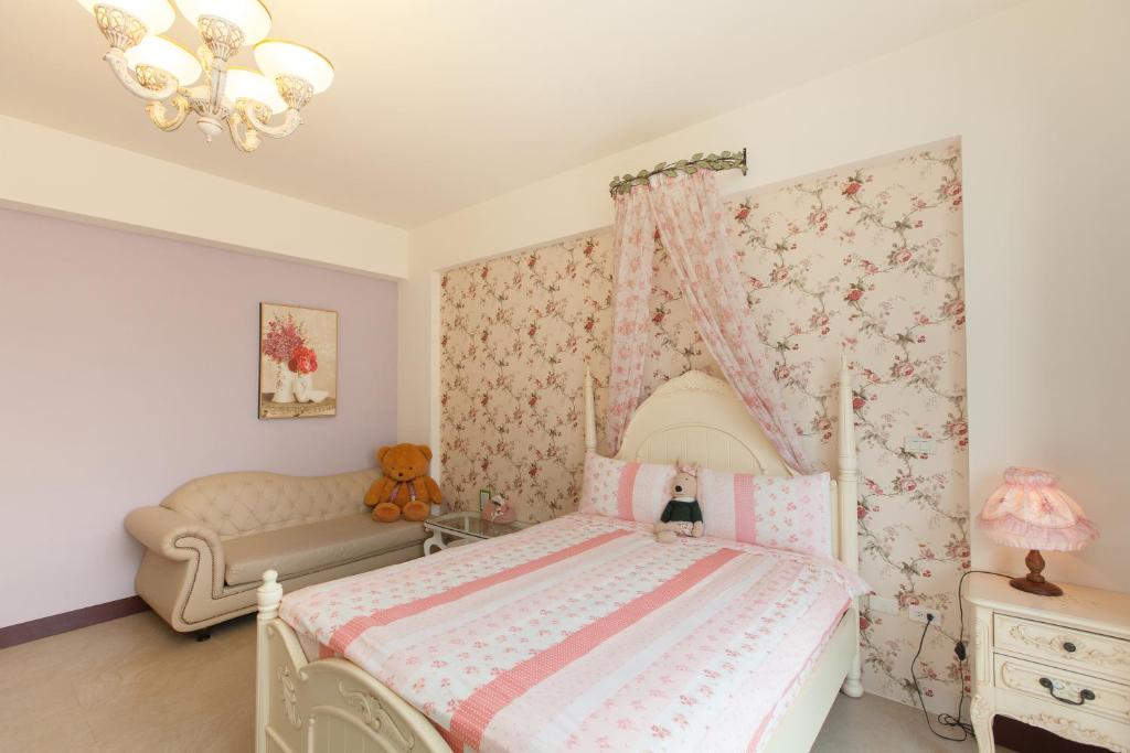 a bedroom with a bed with a canopy at Happiness Homestay in Hualien City