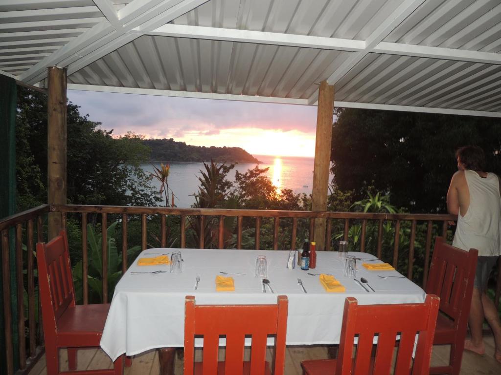 a table on a deck with a view of the ocean at LookOut DrakeBay in Drake