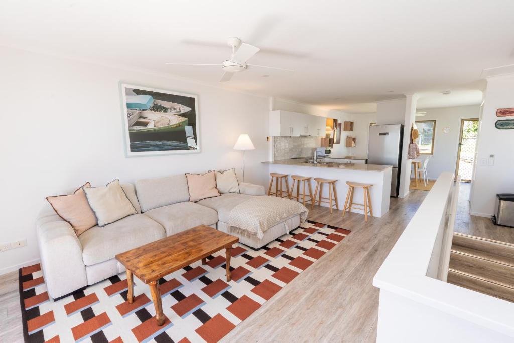 a living room with a couch and a table at Jara - U19 Pandanus Palms Resort in Point Lookout