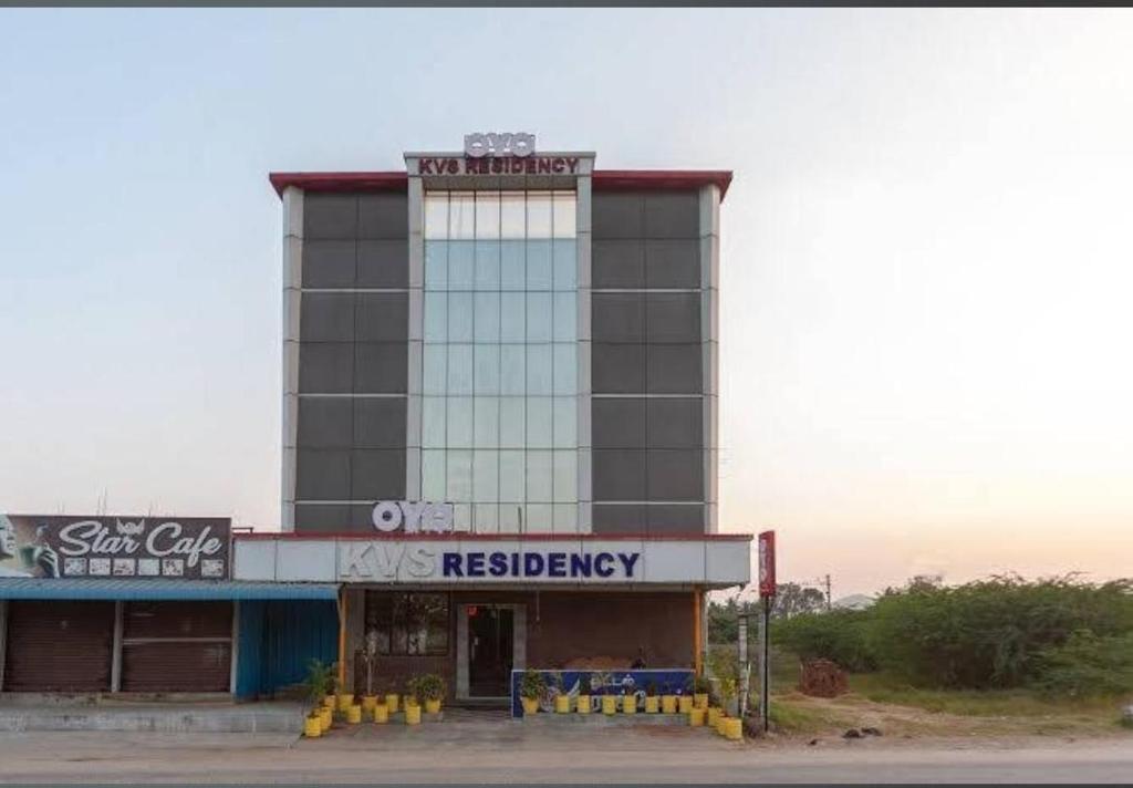 a building with a sign on top of it at KVS Residency in Tiruvallam
