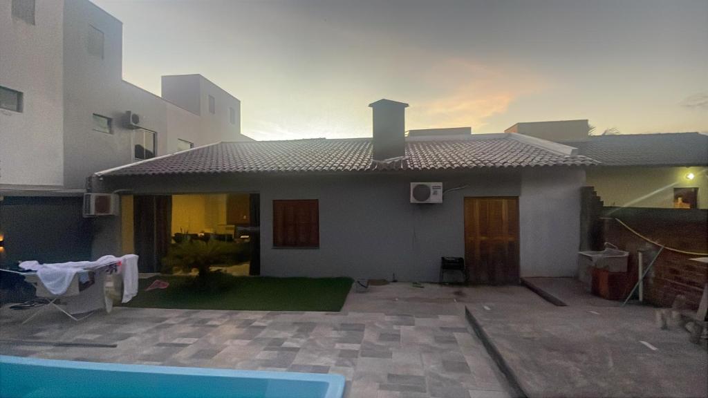 a house with a swimming pool in front of it at CampAmbrosi in Sapiranga