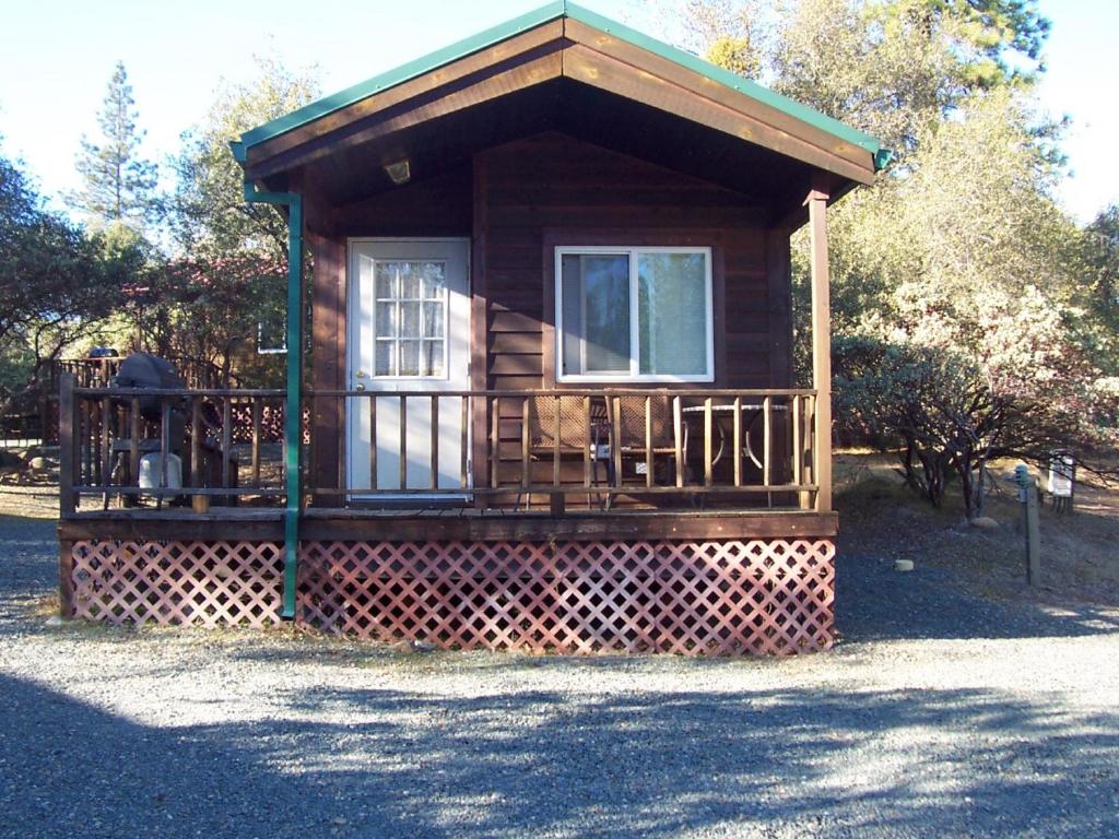 a small cabin with a porch and a balcony at Lake of the Springs Camping Resort Cabin 3 in Oregon House