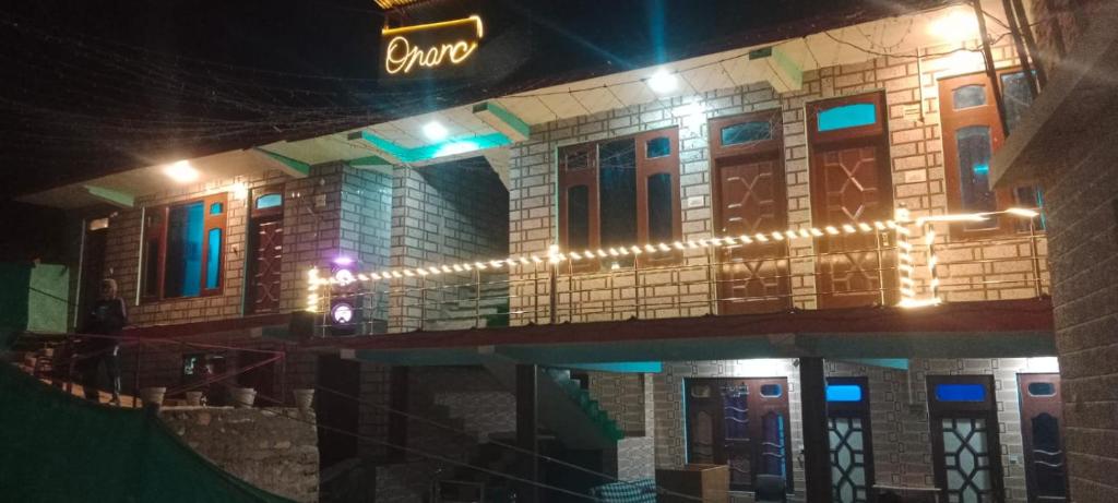 a building with lights on it at night at Onarc guest house in Kasol